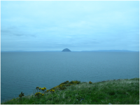 Ailsa Craig, with the Isle of Arran in the background, at right, and the mainland in the background, at left..png
